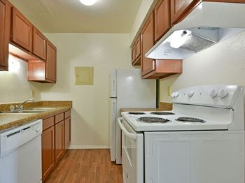 White kitchen appliances at Huntington Place Apartments in Essexville, Michigan